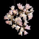Ceramic flower chandelier with glowing white petals on antique gold metal branches