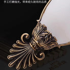 Decorative gold metal leaf and scroll detail for vintage wall sconce