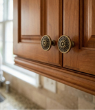 Wooden cabinet with brass flower-shaped knobs and 'Santaya' branding.