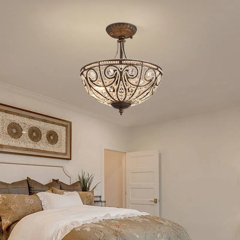 Gold-tone flush-mount ceiling light with crystal-style shade and ornate medallion design