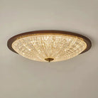 Walnut round flush-mount ceiling light with faceted clear acrylic diffuser, warm illumination