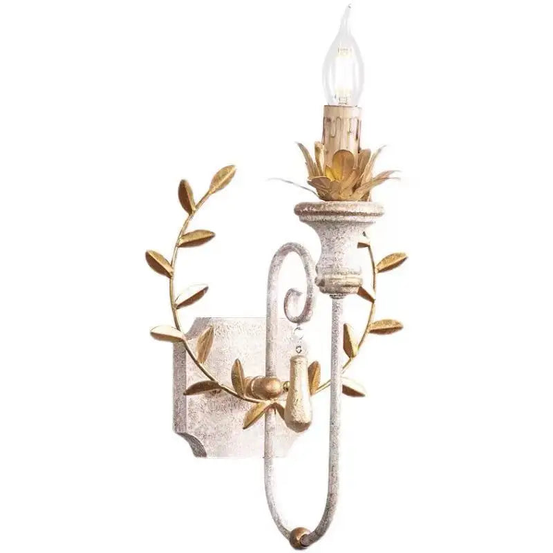 Iron candle sconce with clear LED bulb, gold leaf ring, and textured back plate