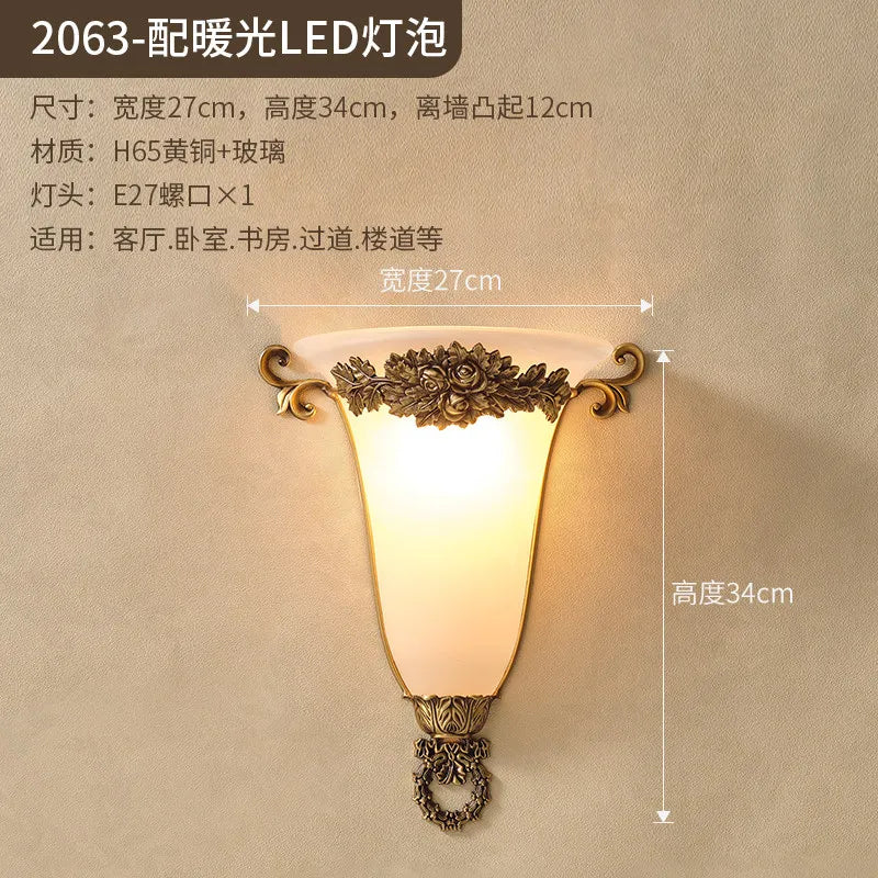 Ornate gold wall sconce with frosted glass shade and rose-inspired metal accents